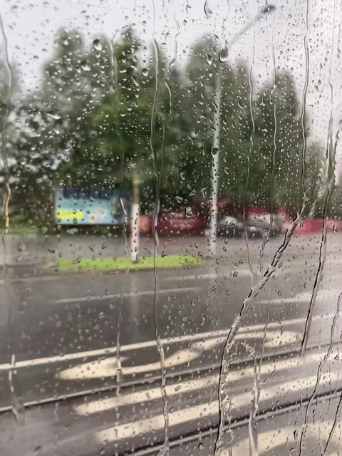 Raindrops on Train Window – Cloudy Day Reflections and Blurred Urban Landscape Stock Footage 306498101