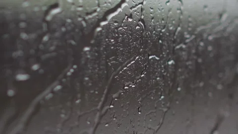 Raindrops on Train Window During Rainy Journey Stockbeeldmateriaal 314534037
