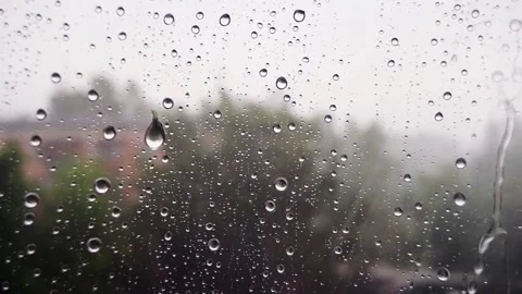 Raindrops trickle down the glass, close-up. Video stock 164708835