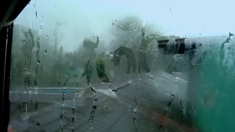 Raindrops trickling down a foggy window on a rainy day Stock-Footage 325612828