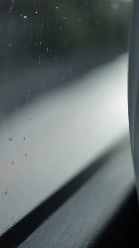 Raindrops On The Vehicle Window, Blurred Background, Vertical Close-Up Shot Stock Footage 292329009