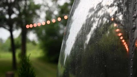 Raindrops on vintage camper with edison light bokeh Stock Footage 162080315