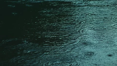 Raindrops, water surface ripples, slow motion, 45 degree angle shot Video stock 332059957