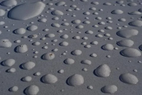 Raindrops on White Plastic Surface, Close-Up Abstract Background Stock Photos