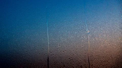 Raindrops on the window with abstract lights Stock Photos