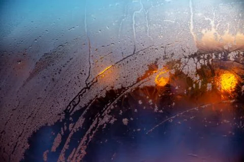 Raindrops on the window with abstract lights Stock Photos