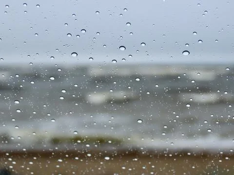 Raindrops on window and waves Stock Photos