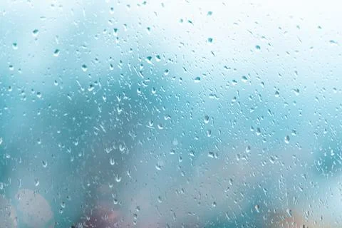 Raindrops on the window, the background is blurred. Gray color. Copy space Stock Photos