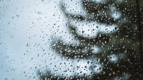 Raindrops on the window in the background Stock Photos