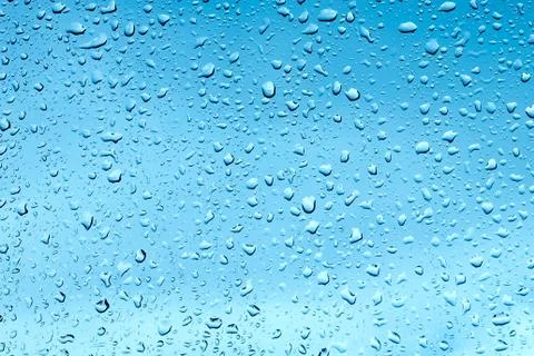Raindrops on the window on a blue background Stock-Fotos