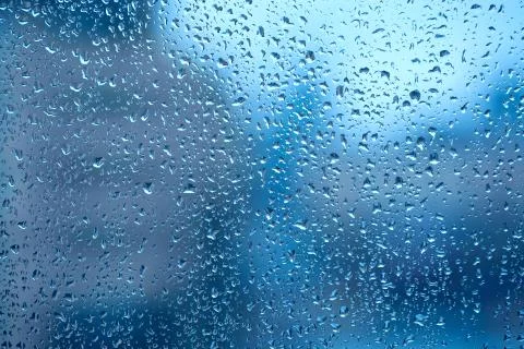 Raindrops on the window on a blue background Foto stock