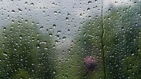 Raindrops on the window with blurred background of cable car in the rainy day Stock Photos