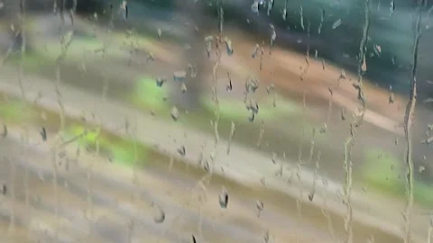 Raindrops on window with blurred background Stock Footage 337800536