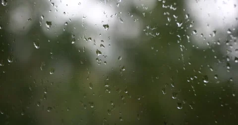 Raindrops on a window with blurred nature background Stock-Footage 341428322