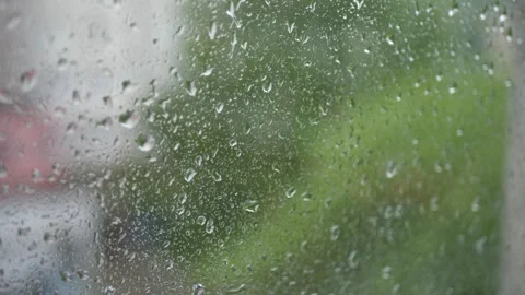 Raindrops on Window with Blurred Urban Background Stock Footage 313821675