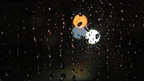 Raindrops on the window,  blurry view of city lights Stock Footage 164718874