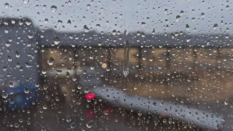 Raindrops on a window, with buildings in the background Stock Footage 342340036