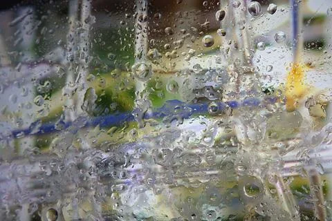 Raindrops on a window with calm and serene indoor or outdoor scene featurin.. Stock Photos