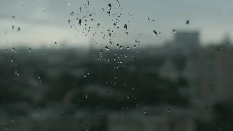 Raindrops on the window city view expressive sadness Video stock 327987539