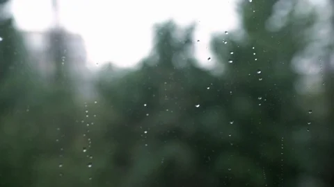 Raindrops on the window close-up, it is raining outside the window Stock Footage 128573523