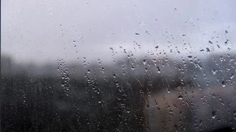 Raindrops on the window, cloudy day and unfocused view of the city. Stock Footage 274095734