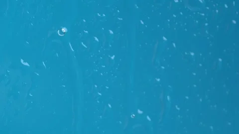 Raindrops on the window dripping down on blue background. Macro Stock Footage 269134976