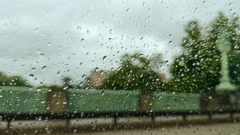 Raindrops on window during overcast day Stock Photos