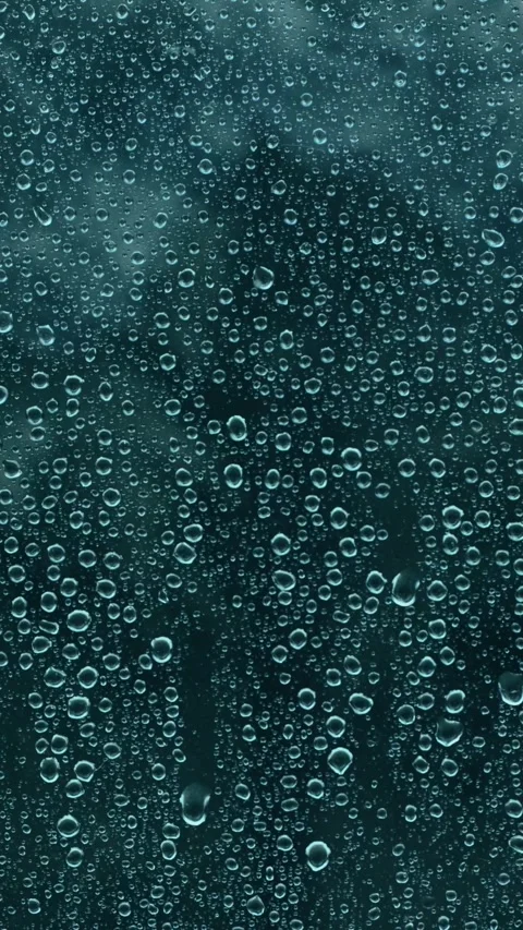 Raindrops on window during rain, moody Vertical 4k to Full HD 23,976fps Stock Footage 311758162