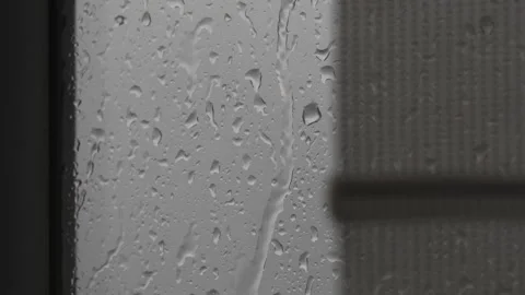 Raindrops on a window during a rainy day Stock Footage 318373776