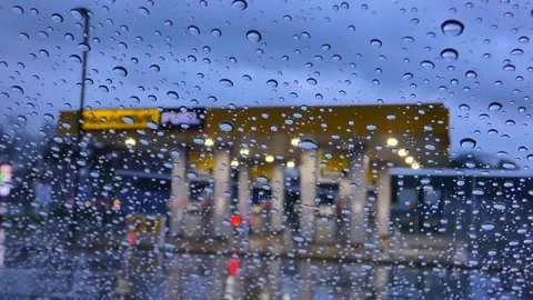 Raindrops on Window at Gas Station During Twilight Stock Footage 327107351
