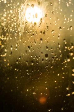 Raindrops on window glass on background of cloudy sky Stock Photos