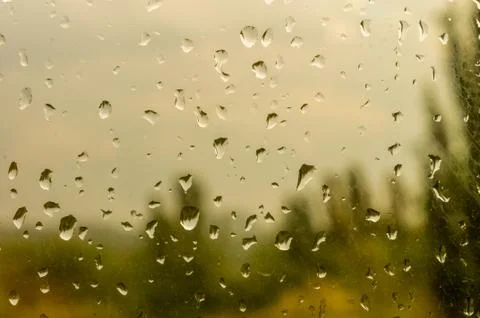 Raindrops on window glass on background of cloudy sky Foto stock