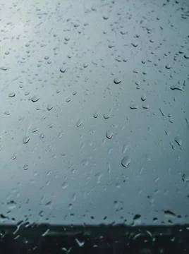 Raindrops on the window glass. Background. Selective focus, blur, defocused Stock Photos