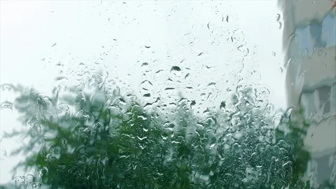 Raindrops on the window glass, buildings in the background. View from the window Stock Footage 113824531