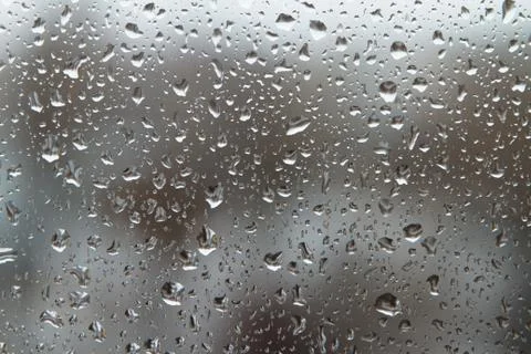 Raindrops on a window glass on a cloudy day. Stock Photos