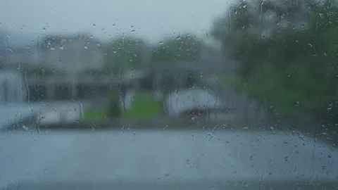 Raindrops on Window Glass During Rainy Evening With Blurred Backyard Stock Footage 341767674