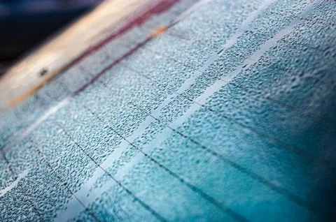 Raindrops on window glass. Selective focus. Rainy city background Stock Photos