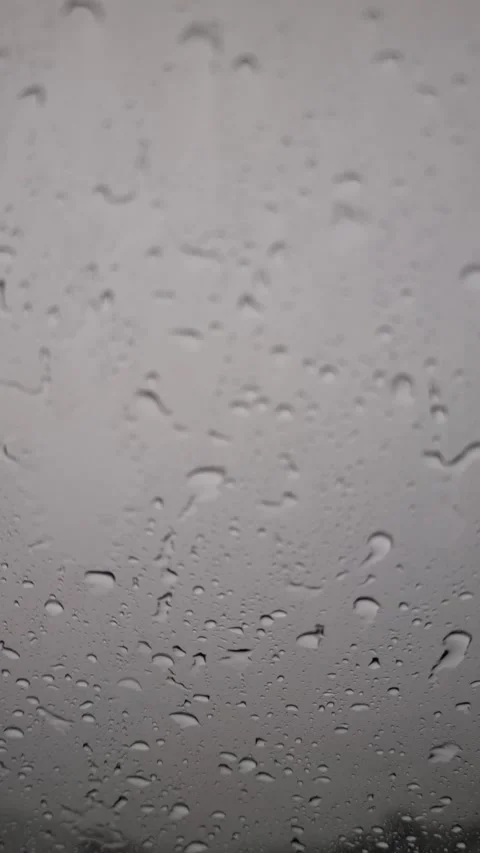 Raindrops on window glass with stormy cloudy sky background Stock Footage 318303472