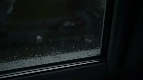 Raindrops on window glass surface, blurred street view, dark stormy atmosphere, Stock-Footage 325697559