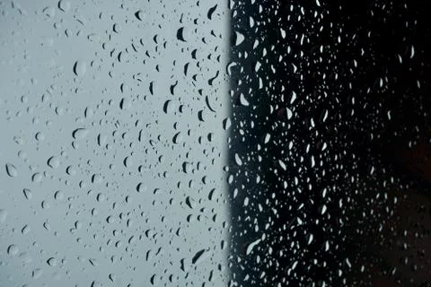 Raindrops on window glass surface. weather abstract background. Stockfoto's