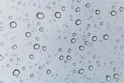 Raindrops on window glasses surface Stock Photos