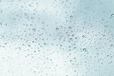 Raindrops on window glasses surface Stock Photos