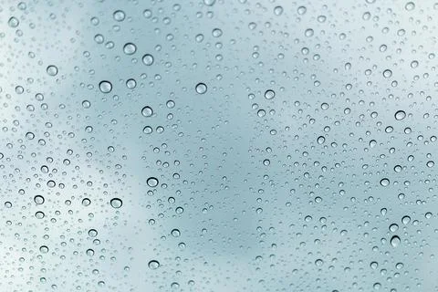 Raindrops on window glasses surface Stock Photos