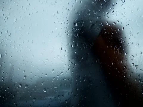 Raindrops on a window with a human texture Stock Photos