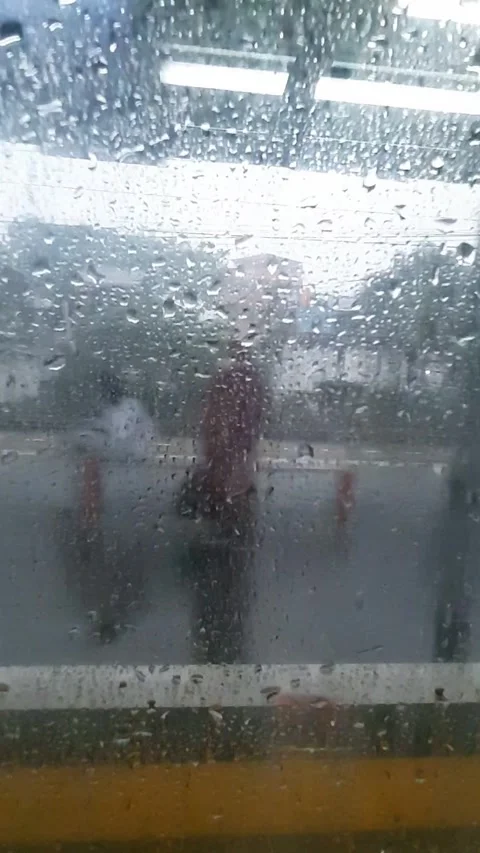 Raindrops on the window of a moving commuter train Stock Footage 281498375