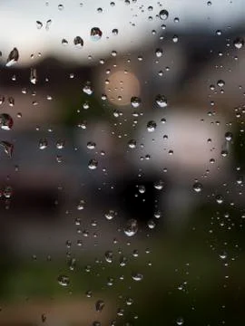 Raindrops on window with nice green bokeh background Stock Photos