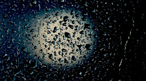 Raindrops on the window at night, defocused light spot Video stock 23724799