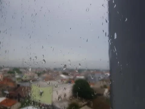 Raindrops on Window Overlooking Cityscape Stock Photos