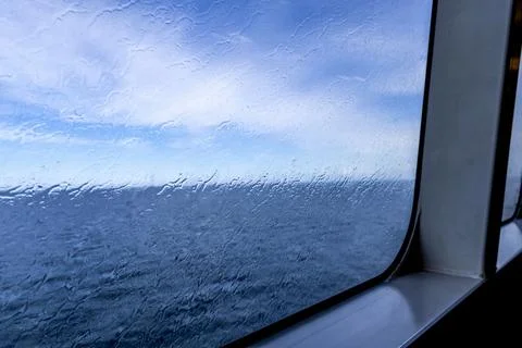Raindrops on the window overlooking the sea. Background with sea and sky on.. Foto stock