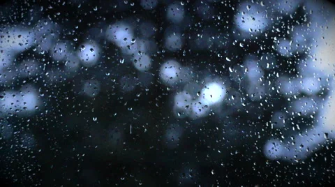 Raindrops on window pain with tress moving in background Stock Footage 40954048
